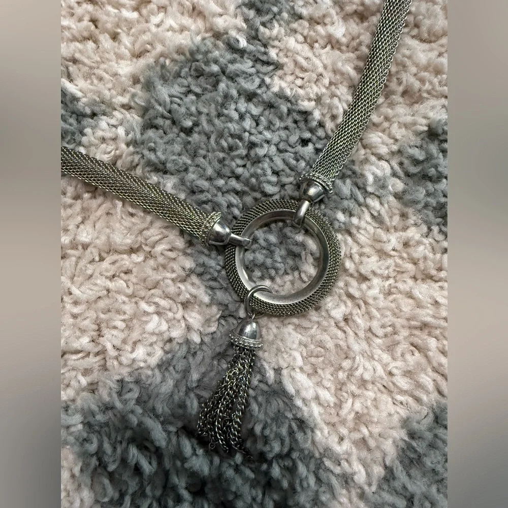 Silver tone chain mail statement belt with tassel and circular latch
